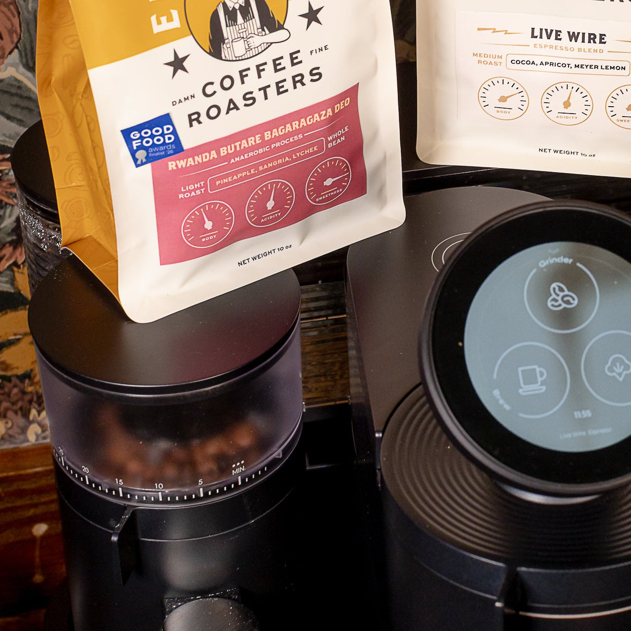 Two bags of Evermore Coffee Roasters on a coffee machine with a patterned background